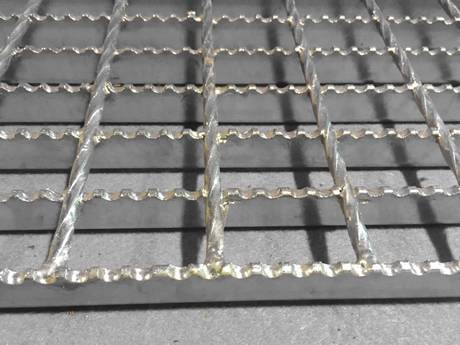 A part of serrated galvanized steel grating.