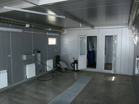 This is an empty dry house with steel grating gully cover.