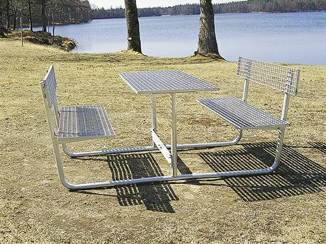 Two benches stand opposite ,and the table in the middle of them.