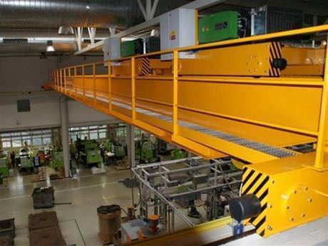 This is an indoor crane maintenance over the working people and machine.