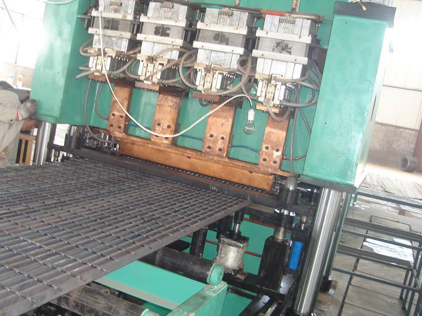 A piece of galvanized steel grating is producing by the machine.