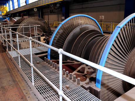 This is a machine surrounded by steel grating operating platform.