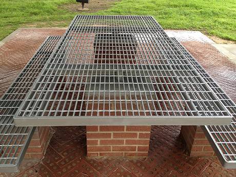 Two steel grating benches around the table on the lounge area.