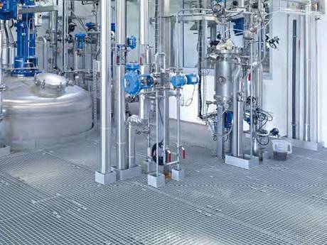 There are many pipes and tanks on the steel grating platform in mining industry.