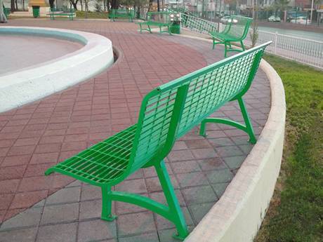 Blue painted steel grating bench in the park.