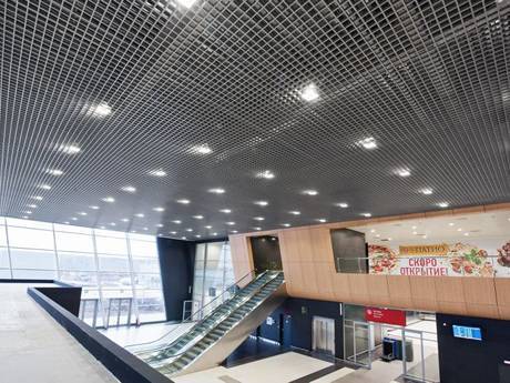 It is steel grating ceiling picture of airport waiting room.