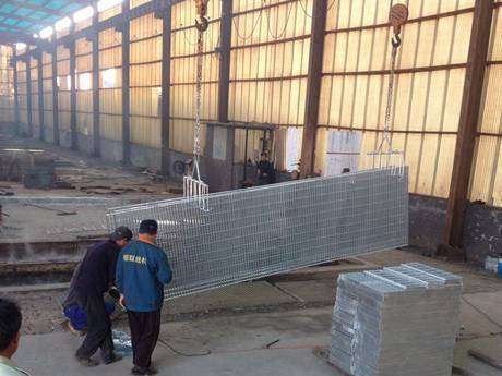 Several workers are hot dipped the steel bar grating.