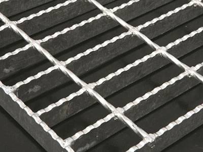 A pieces steel bar grating with serrated surface on the dark gray background.