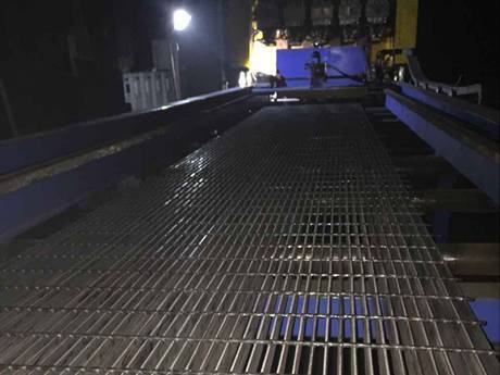 A working machine and a piece of welded steel grating.